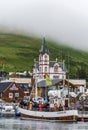 Departure of the excursion boat with passengers from Husavik Port as seen from Skjalfandi Bay. North coast of Iceland, Nordurting Royalty Free Stock Photo